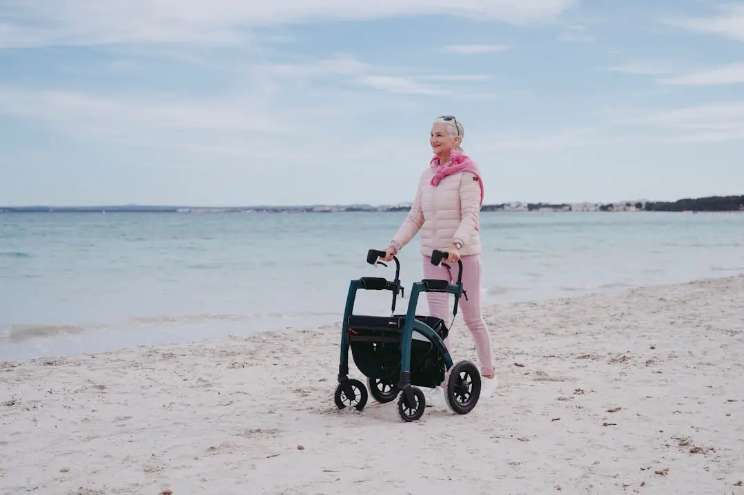 a woman standing on a beach next to a cart