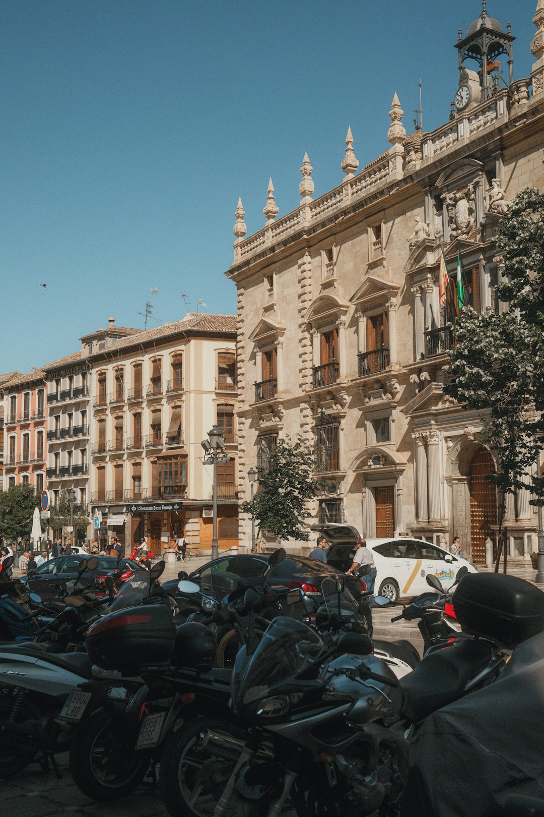 A group of motorcycles parked in front of a building
