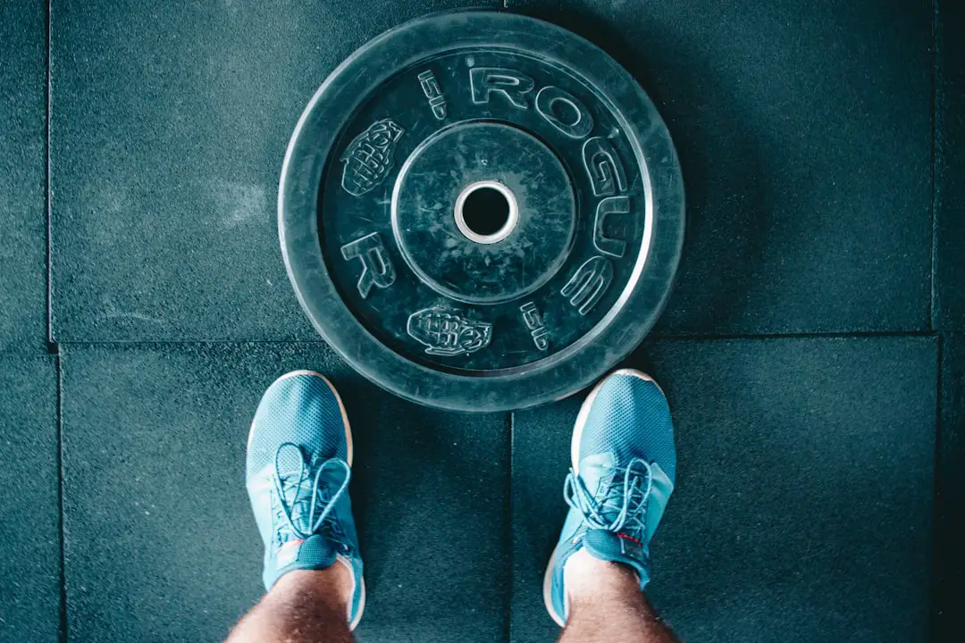 🧠 FAQs: Your Burning Questions About Walkathons and Health Answered by Walkathon Benefits person standing beside black weights