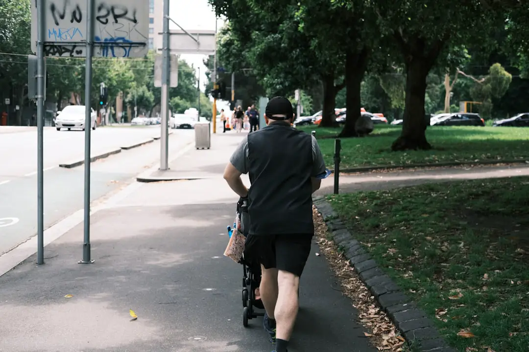 A man riding a bike down a sidewalk